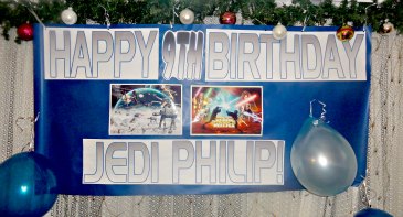 9 yr old Jedi star wars birthday banner was a great hit with a couple of birthday balloons on streamers down the sides