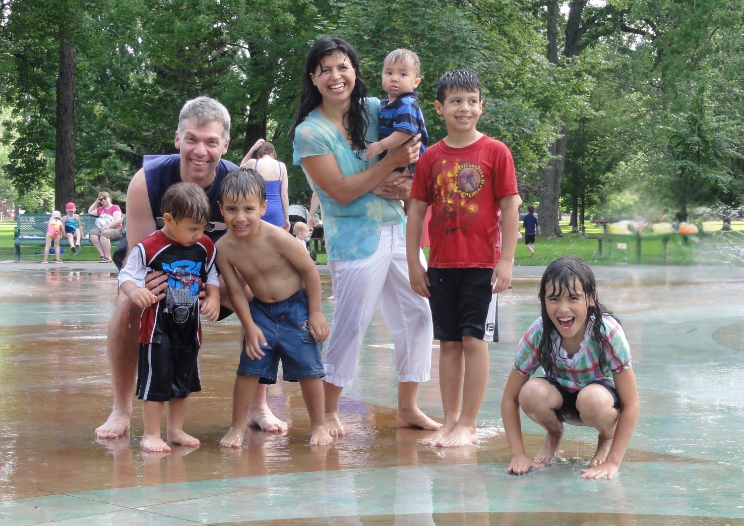 Family enjoying a summer day at the water park, laughing and splashing together — a moment of joy and togetherness from Family Life Parenting.