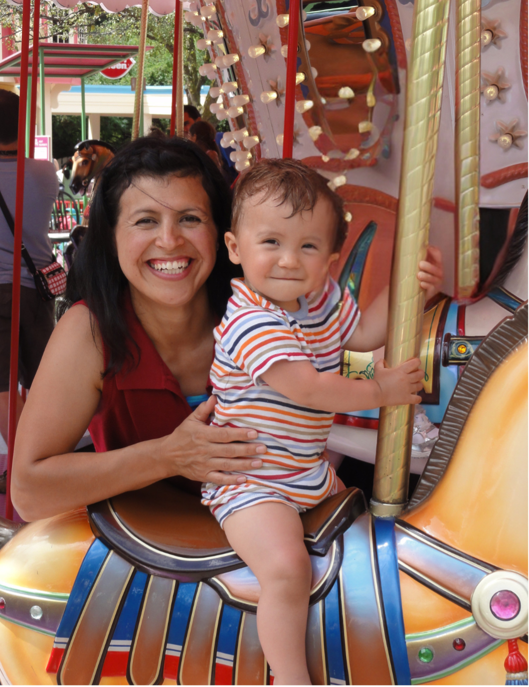 Mom and young child on a carousel, joyful first experience, smiles and bright colors.